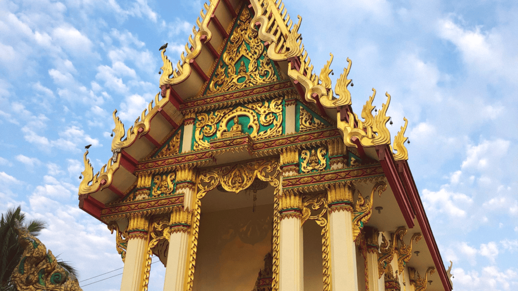 A beautiful and ornate local temple with bright colours and gold at The Better Life Place wellness retreat in Thailand.