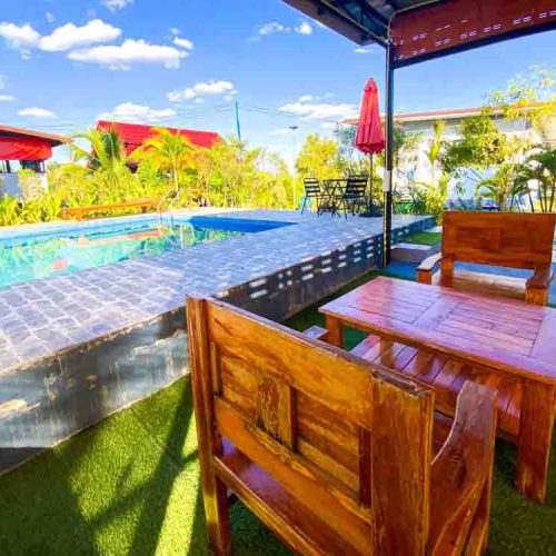 Seats near the swimming pool at The Better Life Place Rehab in Thailand.