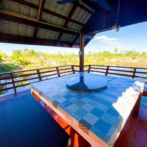 Dining table with beautiful view over the fish pond at The Better Life Place Rehab in Thailand.